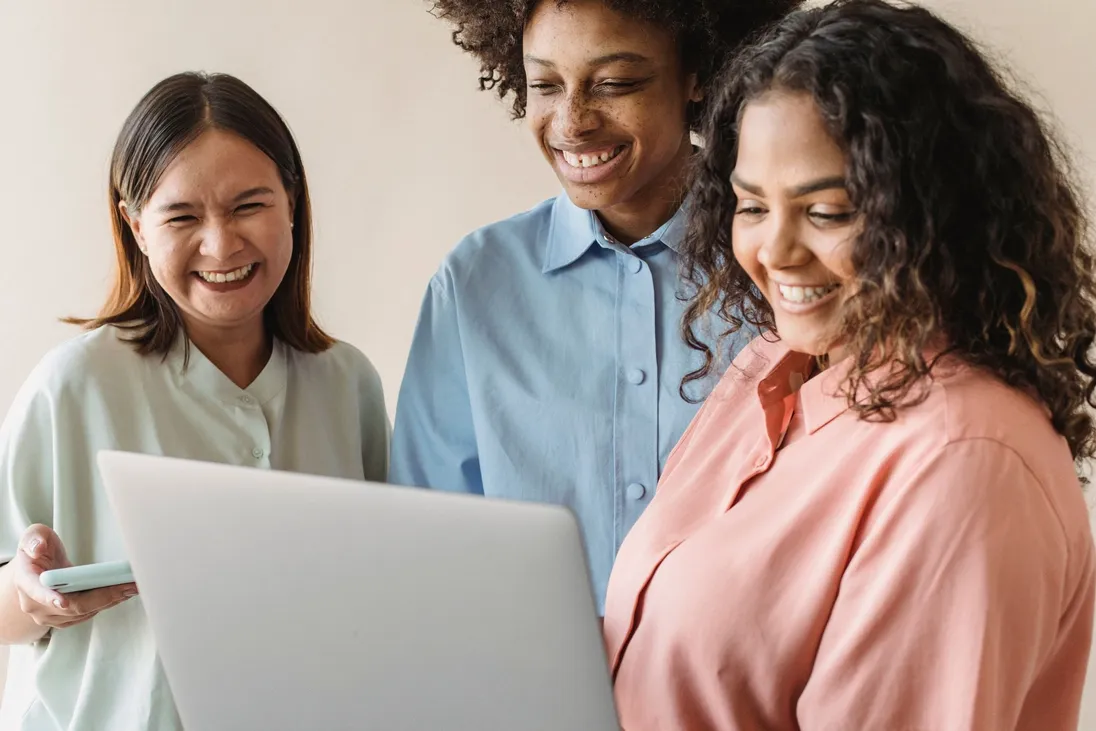 A finance team reviewing numbers together on a laptop