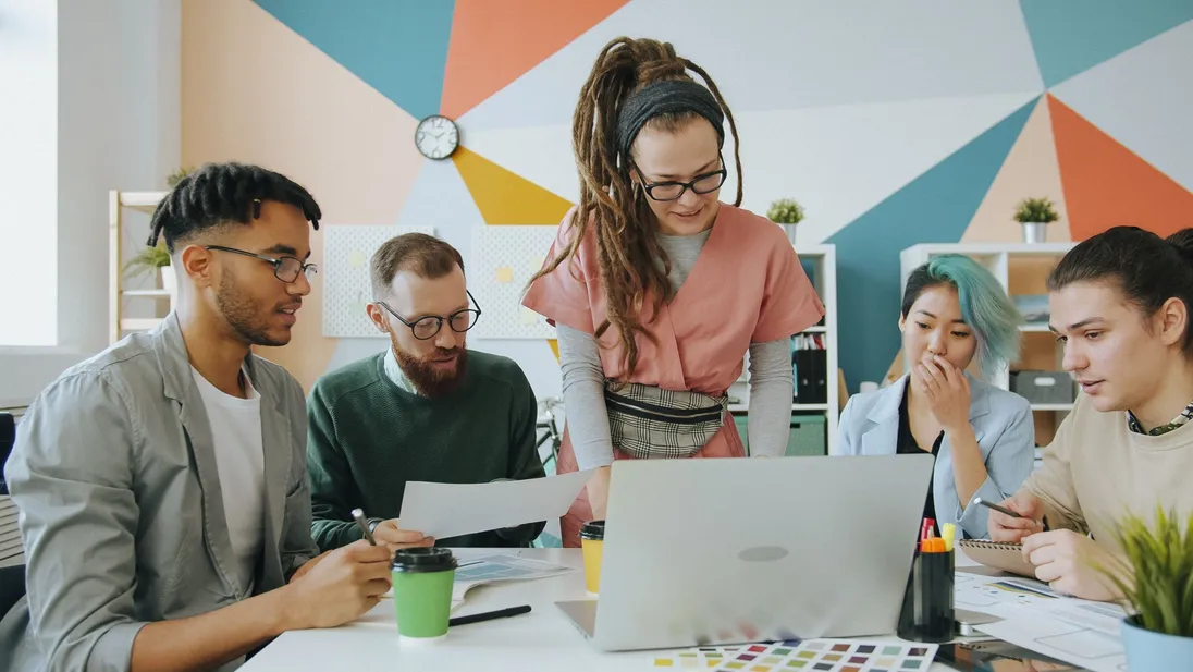 A revenue team working together around a laptop